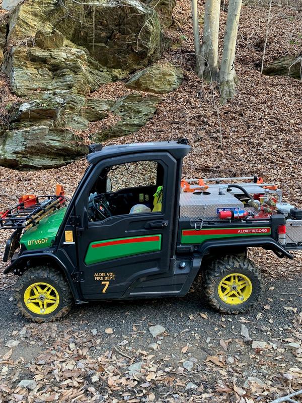 UTV607 is a 2018 John Deere Gator XUV835M.  This has an enclosed cab with seating for three personnel, heat and air conditioning, and can perform wildland fire and EMS patient transport from remote locations.  UTV607 has a 65 gpm pump and a 55 gallon water tank. It carries two brush rakes, 141' of 1&quot; forestry hose, trail maps, and other brush fire equipment.  Additional fire and EMS equipment can be transferred to UTV607 from WLSU607 as needed per the incident response. Aldie VFD Photo