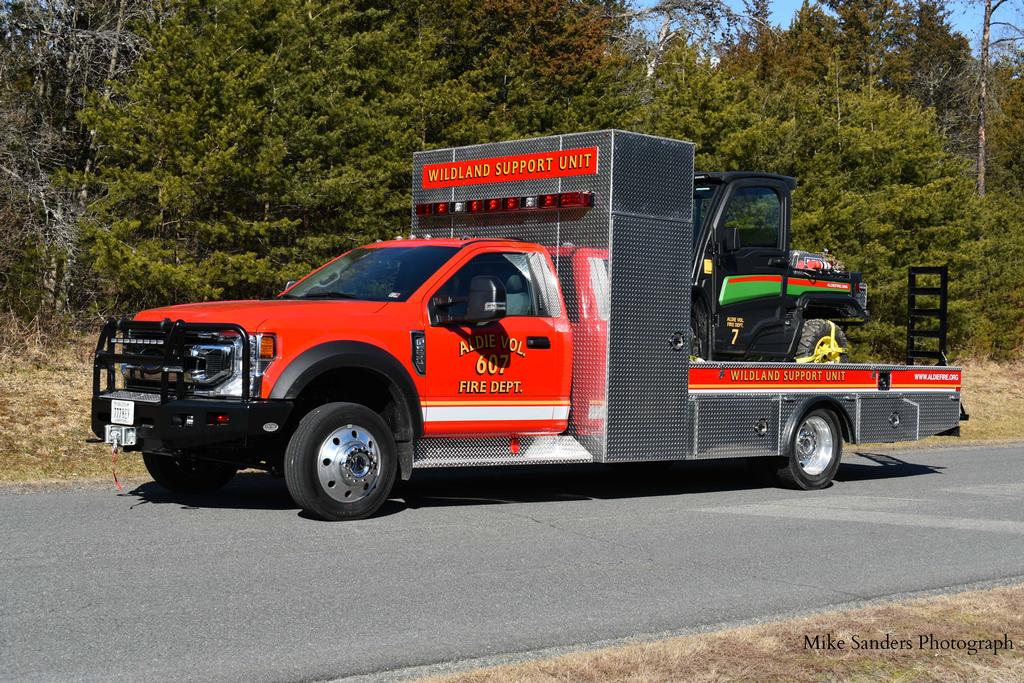 Wildland Support 607 and Brush UTV 607. WLSU607 is a 2020 Ford F-550 4x4 with a 7.3 liter gasoline engine with a 10 speed automatic transmission, 19500 pound GVWR package, and seating for two.  WLSU607 is 9&rsquo;4&rdquo; tall, 8&rsquo;1&rdquo; wide, and 29&rsquo;8&rdquo; long.
With the UTV loaded on the unit, its certified weight is 15,500 pounds.
WLSU607 has emergency lights, siren, compartment lights, and work/ground lights, as well as a backup alarm and camera.  All exterior stepping, standing, and walking surfaces have slip-resistant surfaces to meet NFPA 1901 Standards. 
WLSU 607 has two 12,000 lb. winches;  One on the front, one on the bed. The front winch may be used to winch the truck. The bed winch is designed only to winch a disabled UTV onto the bed. Each winch has 125&rsquo; of cable.
Mike Sanders Photo